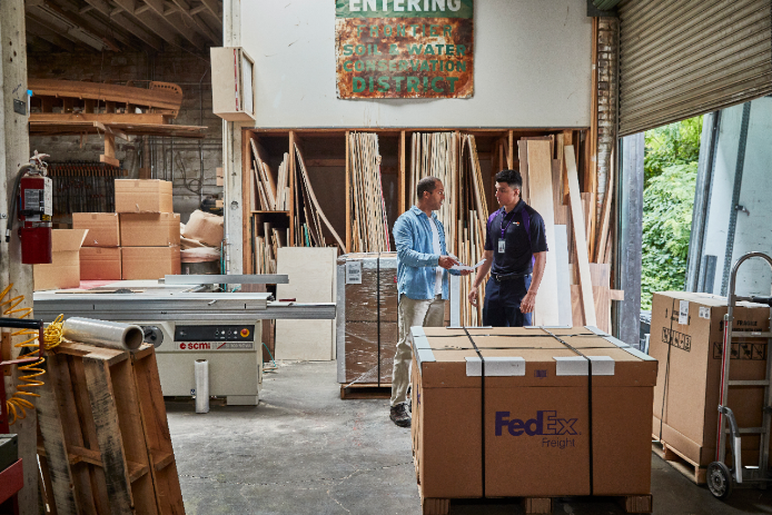 Two men talking inside warehouse