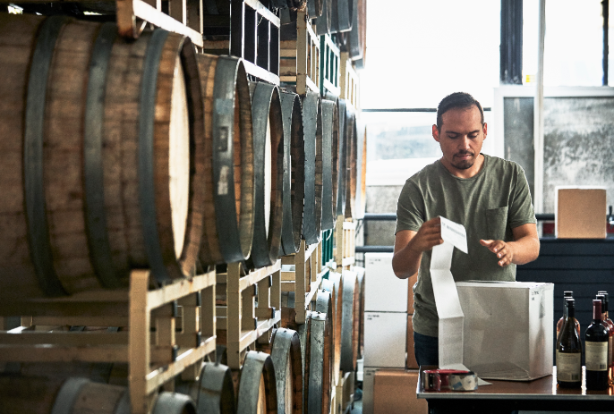 employee at distillery packaging bottles