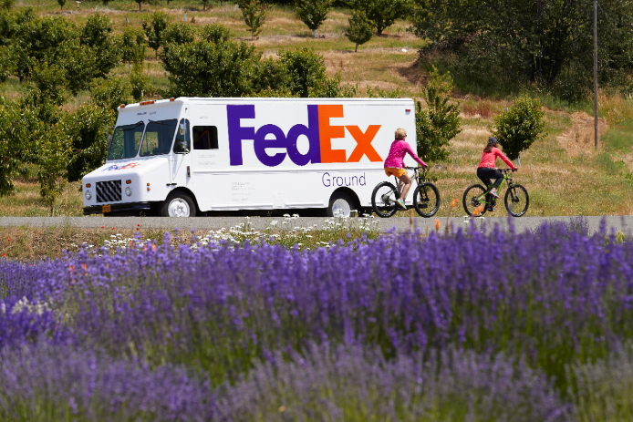 FedEx Ground van driving down road