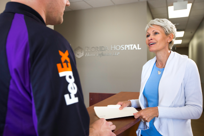 A doctor talking to a FedEx delivery driver A doctor talking to a FedEx delivery driver
