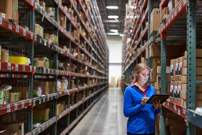 female employee scanning boxes in warehouse