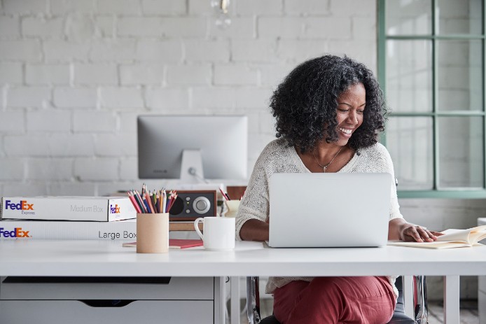 Woman in office with FedEx package