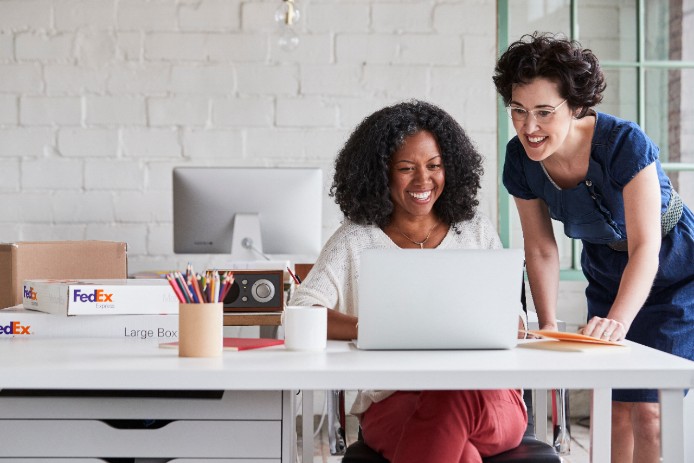 two women looking together at a computer