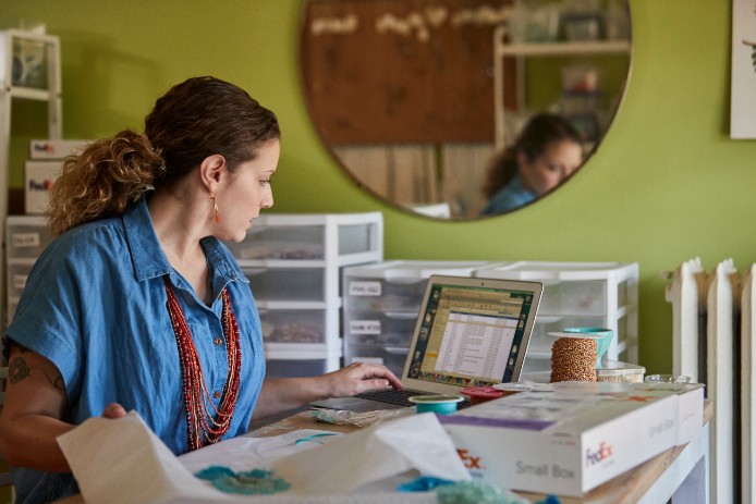 Woman at desk looking at laptop