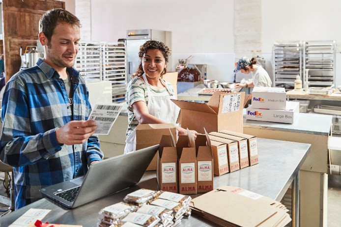 Man and woman packing supplies together