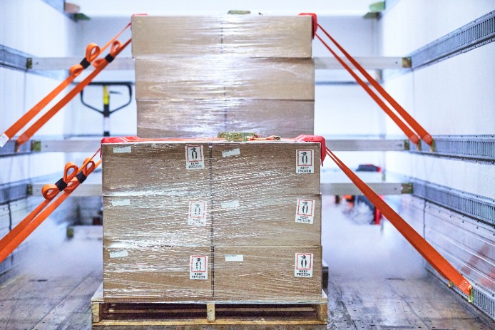 Palettes are packed and secured in a refrigerated cargo hold