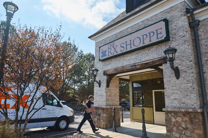 FedEx courier delivering a package to pharmacy