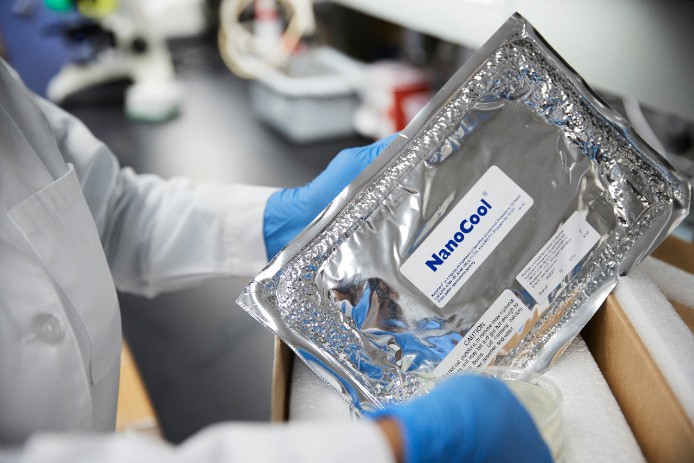Lab tech unpacks cold shipping packaging
