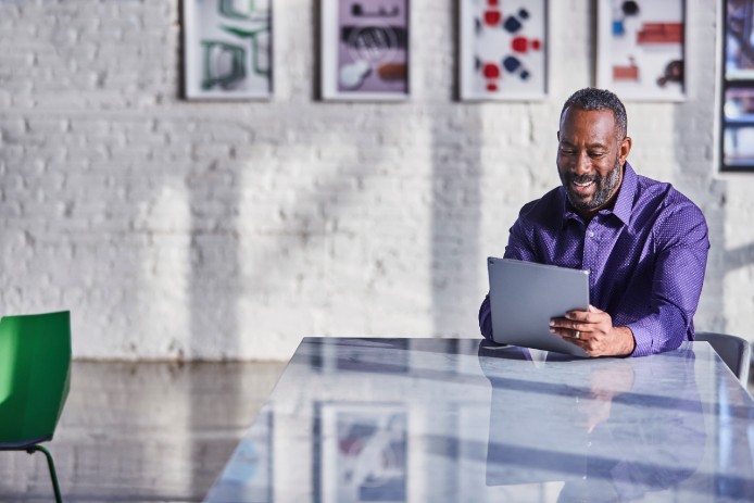 man in office on tablet
