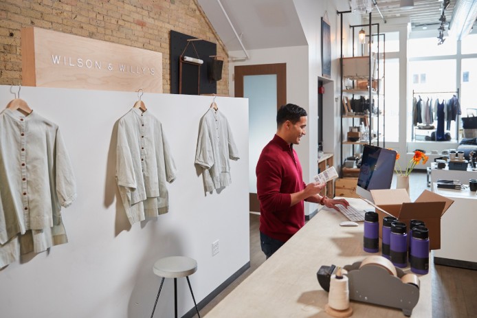 A man on a computer behind a counter