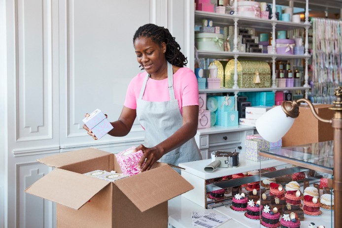 Woman packing perishable food into box