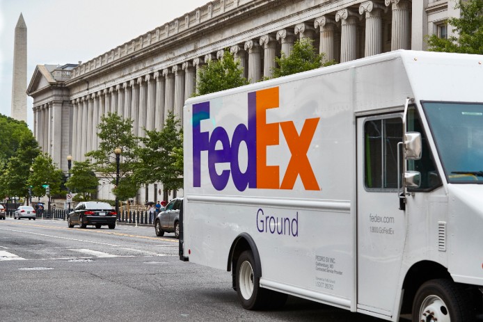 FedEx Ground truck driving in a city