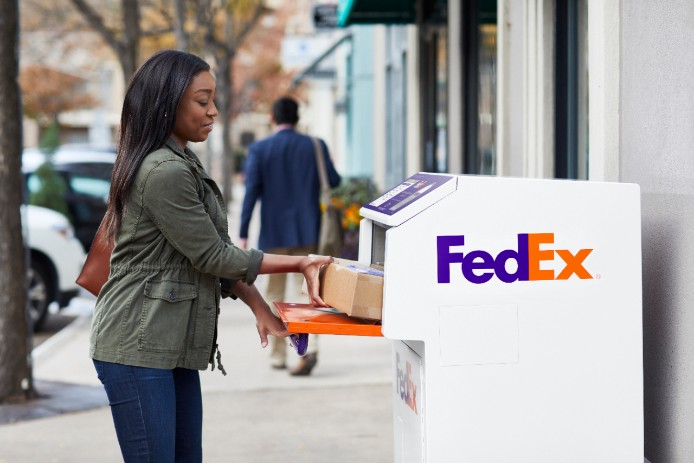 woman returning package in fedex dropbox
