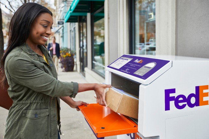 woman using FedEx dropbox
