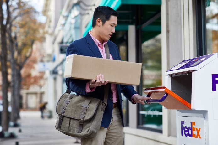 man using FedEx dropbox