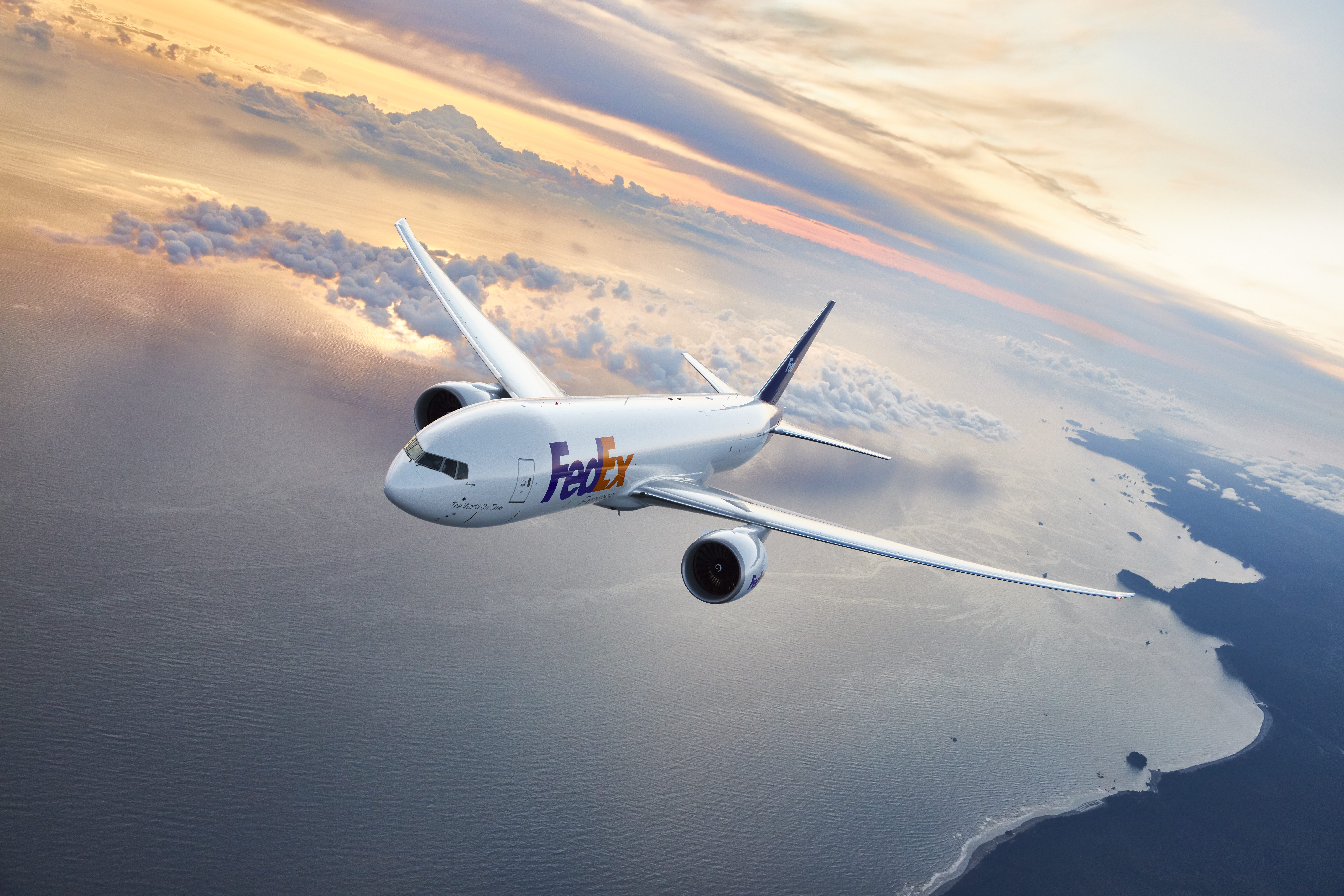FedEx plane flying in sunrise