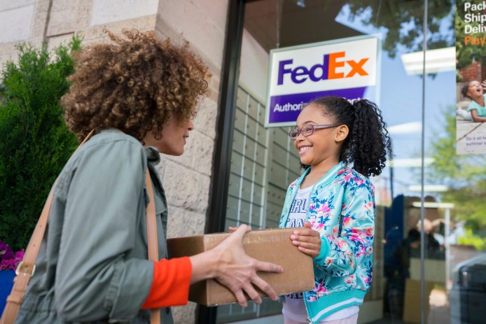 mom and daughter with FedEx package
