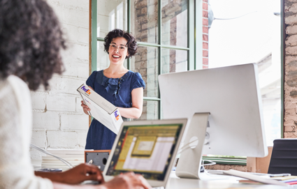 Business woman picks up FedEx package to supplement her business