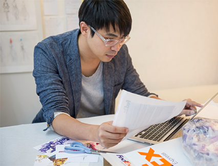 Man with FedEx package on computer
