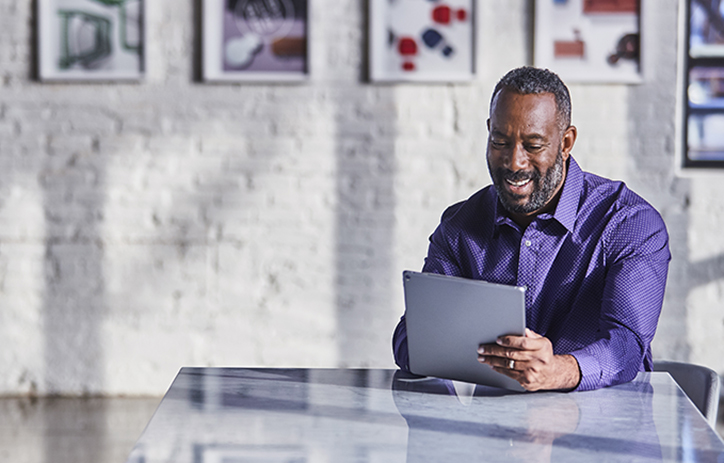 man in office on tablet