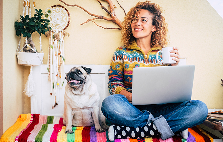woman on couch with dog, coffee
