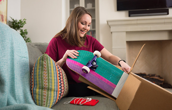 woman opening FedEx package