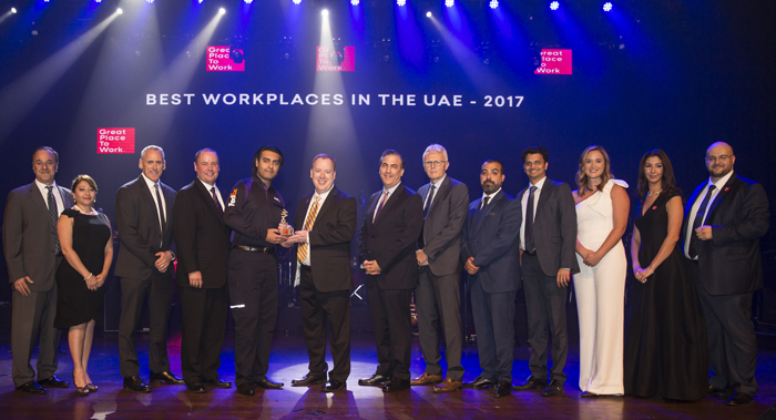 FedEx Employees holding award for Best place to work medal