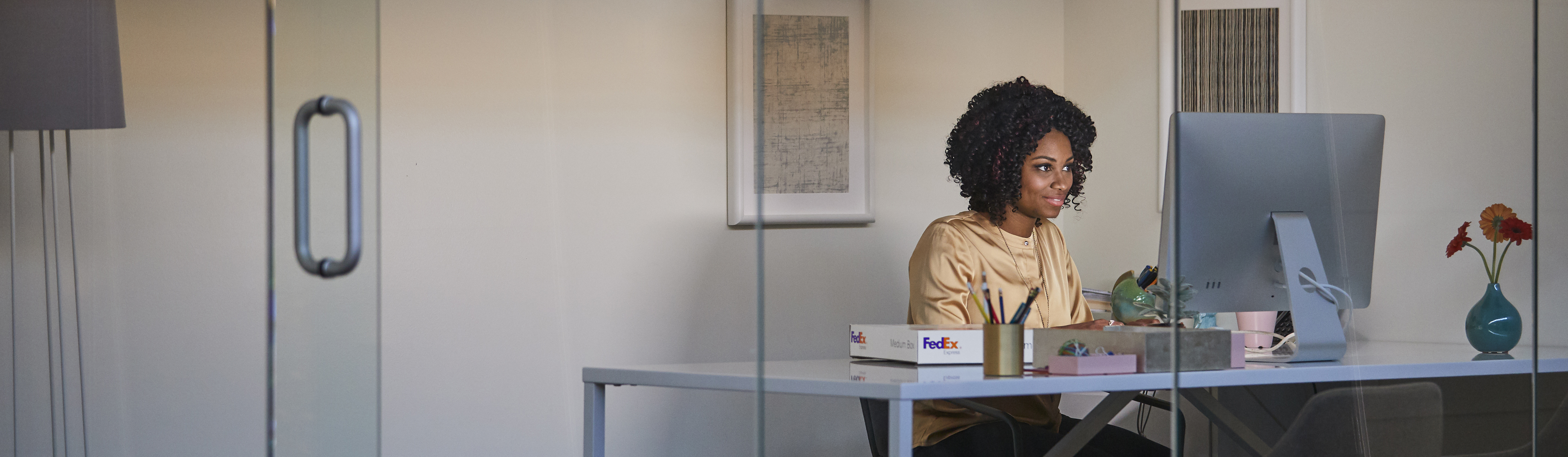Woman at a desk looking at a computer