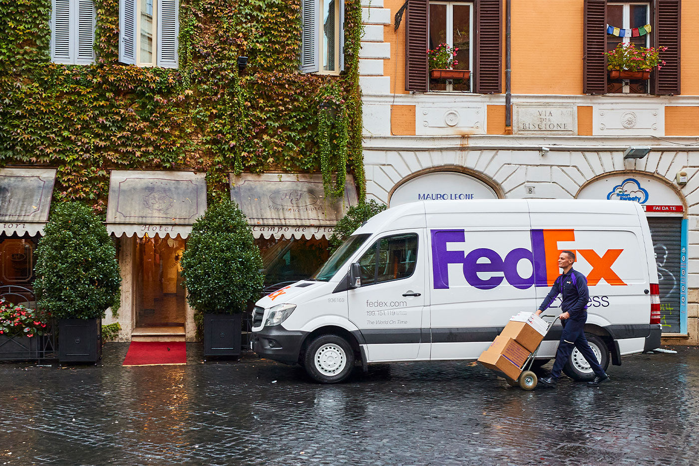Delivery van in front of buildings