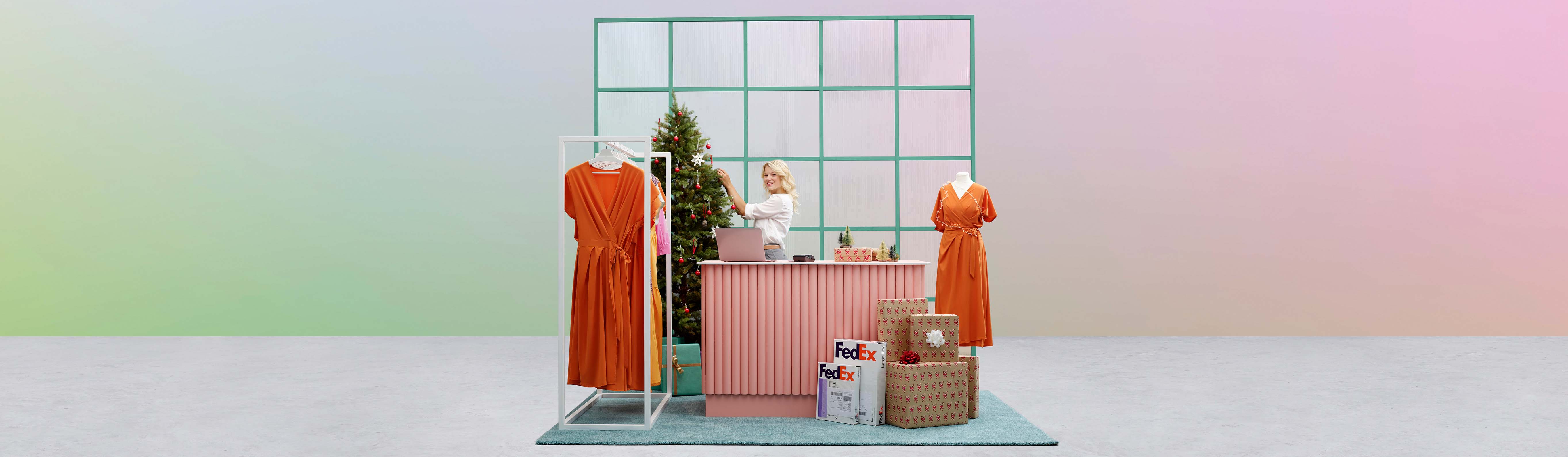 Shop clerk decorating a Christmas tree behind a desk