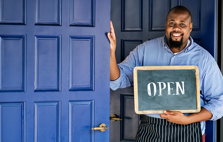 Shopkeeper with open sign