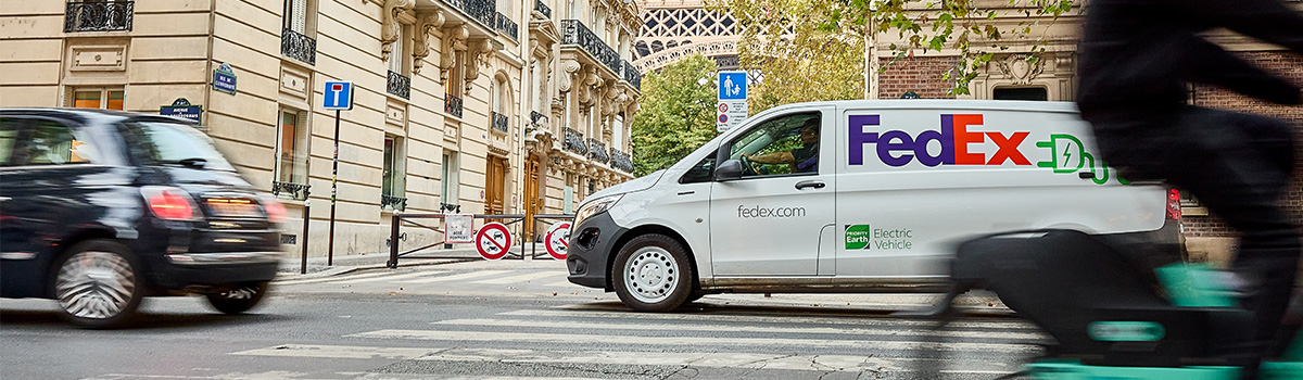 Electric FedEx Express van with colorful houses