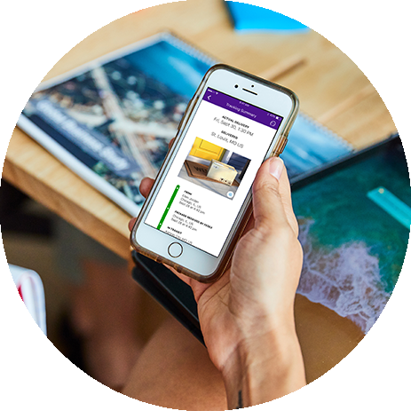 A person holds a smartphone showing a shipment tracking summary on the screen
