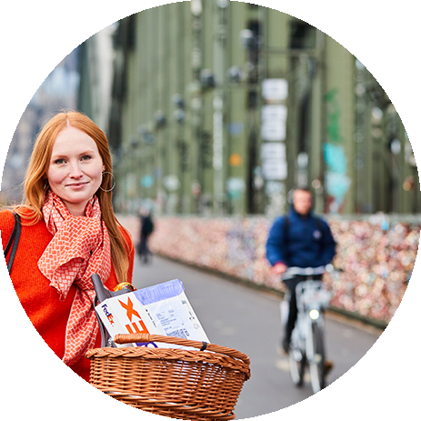 Person on a bike with a FedEx box in a basket