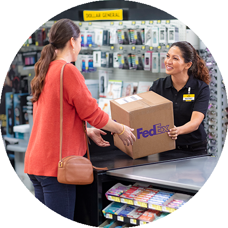Customer receiving a Brown FedEx box from an employee