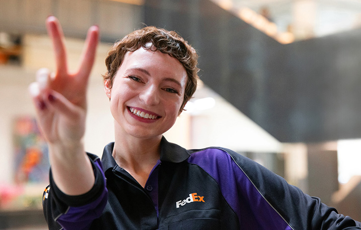 FedEx employee with peace sign