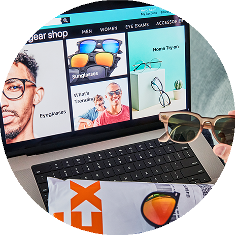 Laptop with a FedEx envelop on the keyboard and a sunglasses website on the screen