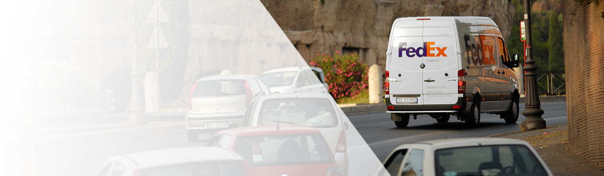 FedEx van driving through city streets