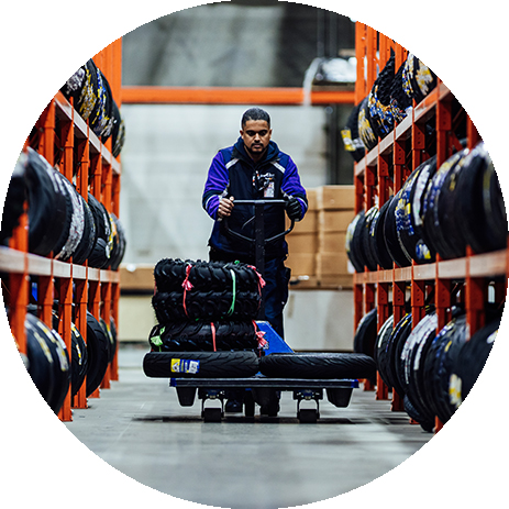 Worker pushing cart with tires