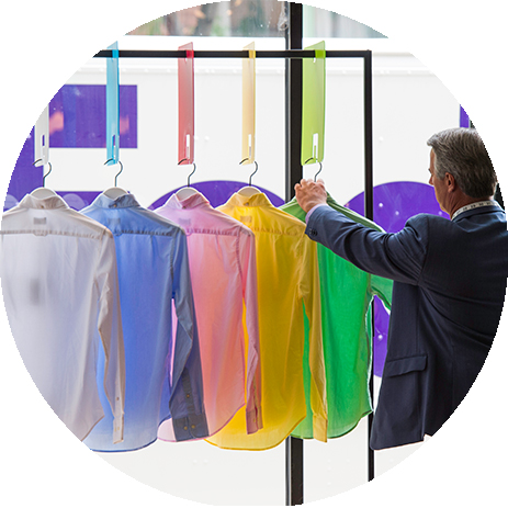 Man looking a luxury shirts on hangers