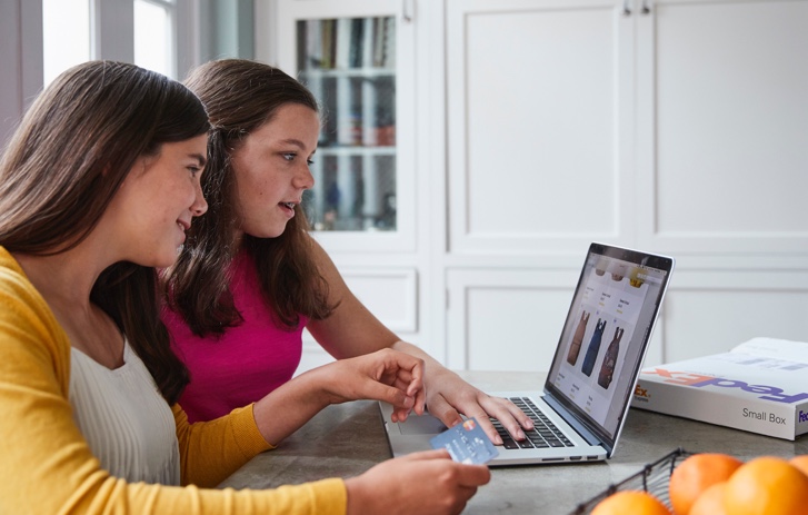 Two girls buying clothes online