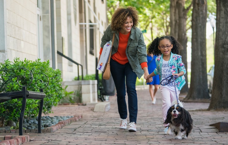 woman and daughter with fedex package