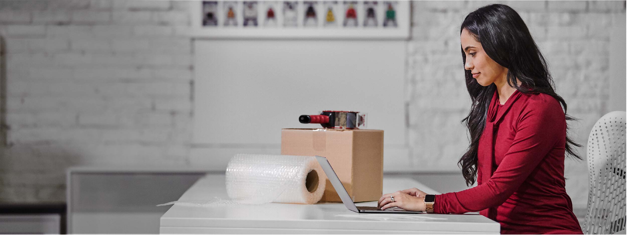 woman packing fedex box