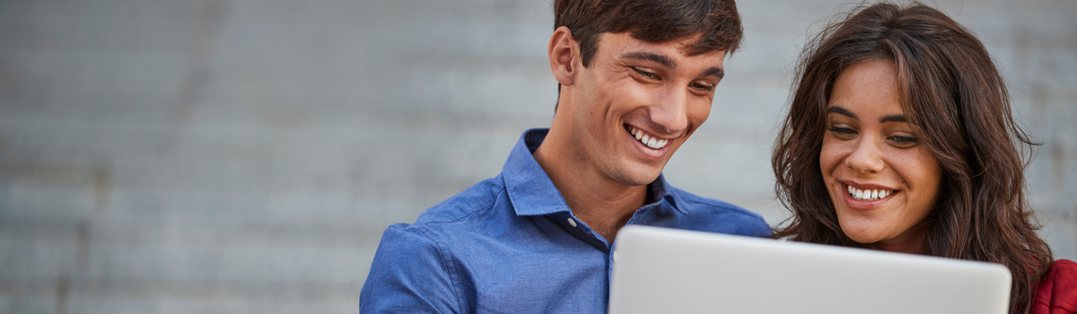 Two people looking at a tablet