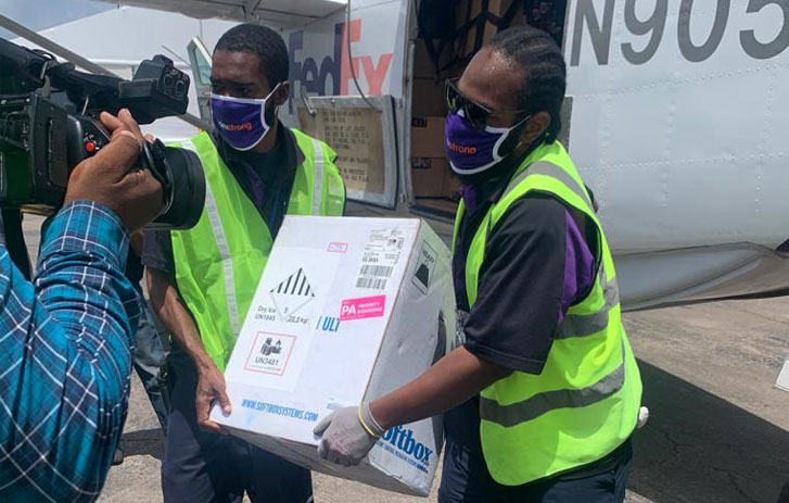 FedEx team members delivering temperature-sensitive vaccines to the Caribbean