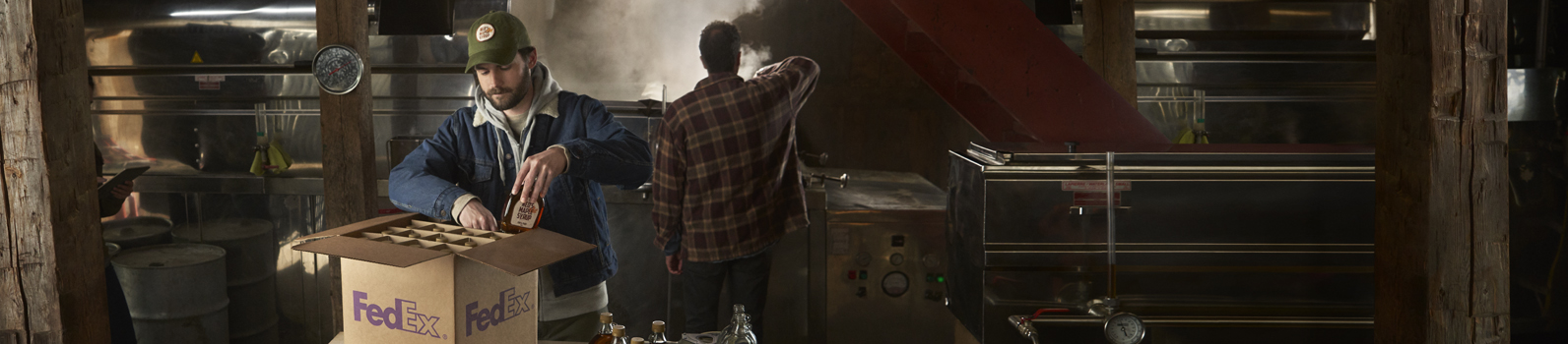 A man packing a box in a maple syrup factory