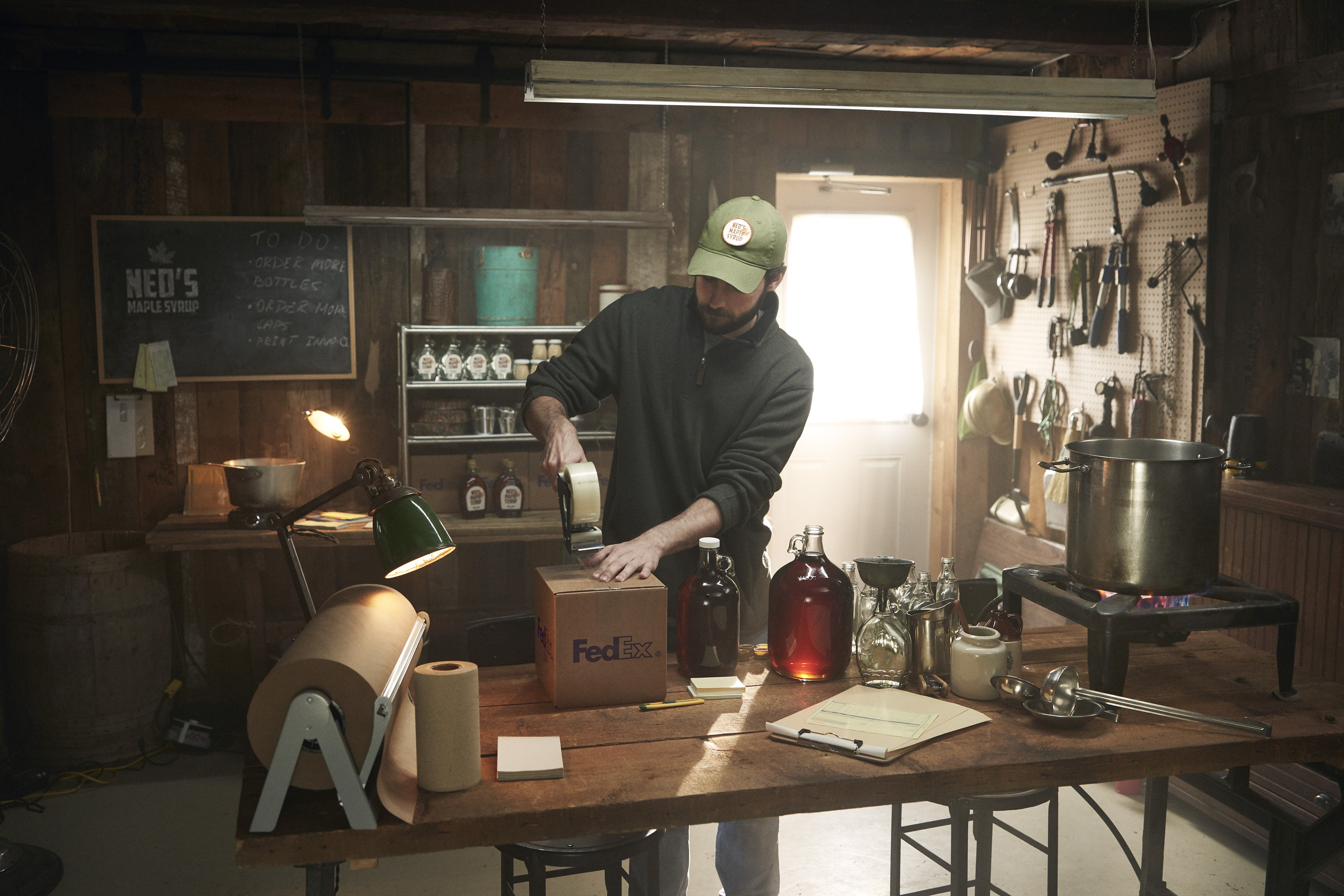 small business owner packing maple syrup into a box