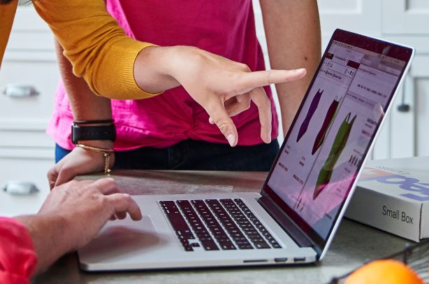 A woman types on her computer