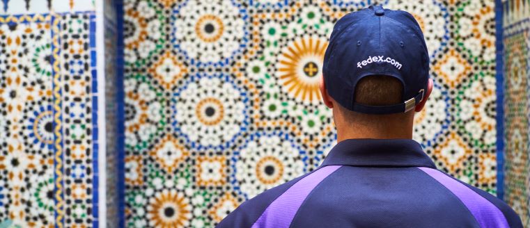 Team member facing a colorful wall