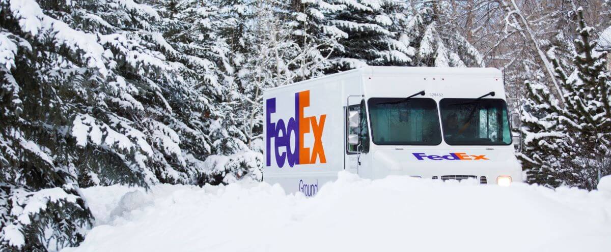 FedEx truck driving through snow